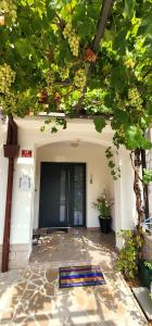 a front door of a building with a tree at Comfort Studio Bella Lucia in Portorož