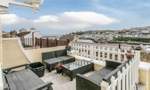 d'un balcon avec des chaises et une vue sur la ville. dans l'établissement Sandy Bottom, à Brixham