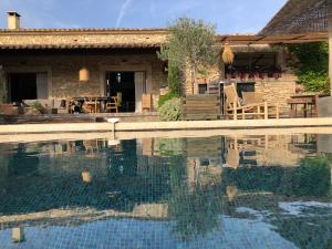 a house with a swimming pool in front of it at Villa Cabrida in Cabrières-dʼAvignon