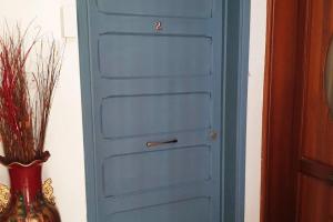 a blue door in a room with a vase at Valletta Apartment with Harbour Veiw in Valletta