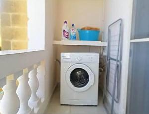 a washing machine in a laundry room with a window at Valletta Apartment with Harbour Veiw in Valletta