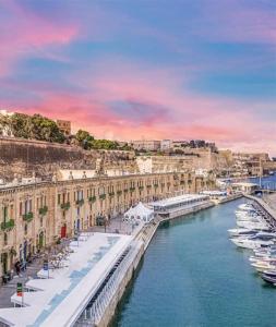 a view of a river with boats and buildings at Valletta Apartment with Harbour Veiw in Valletta