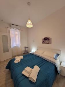 a bedroom with a large bed with towels on it at Casa Vacanze L'Ortensia in Bagheria