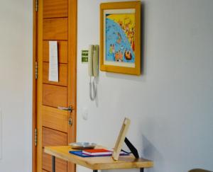 a table with a phone on a wall next to a door at Apartamento da vila by Morna Homes in Vila Baleira