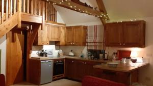 a kitchen with wooden cabinets and a counter top at The Old Cowshed in Roundwood