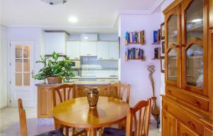 a kitchen and dining room with a wooden table at Beautiful Apartment In Santa Pola in Santa Pola