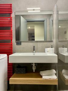 uma casa de banho com um lavatório branco e um espelho. em Rivacentro 2 em Riva del Garda