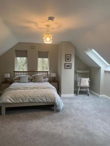 a bedroom with a large bed in a attic at The Mews in Newbridge