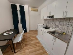 a kitchen with a table and a sink and a counter at Creative studio 4 in Novi Sad