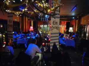 a group of people sitting at tables in a restaurant at Le Ski Lodge & Steakhouse in Storlien