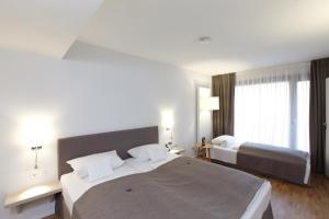 Un pat sau paturi într-o cameră la Hotel Klingelhöffer