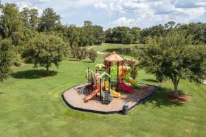 a park with a playground in the grass at Ainsdale Haven home in Kissimmee