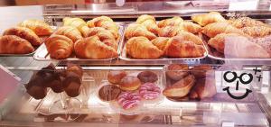 a display case filled with lots of different types of donuts at Regina Viarum in Mirabella Eclano