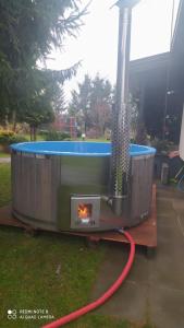 a outdoor grill with a fire in a yard at Wrota Biebrzy in Wroceń