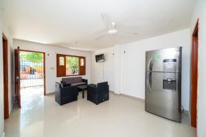 uma sala de estar com um frigorífico e um sofá em ApartaHostal Mafelo em Taganga