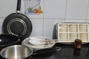 a kitchen counter with a tray of food and a pan of bread at Yash's Congenial stays - 1 Rk independent place. in Lucknow