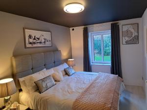 a bedroom with a large bed and a window at SeaView Apartment Suite in Cobh