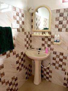 y baño con lavabo y espejo. en Wasana Villa Mirissa, en Mirissa