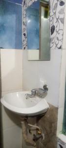 a bathroom with a sink and a mirror on the wall at Laxmi Homestay with main square view in Bhaktapur