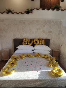 Una cama con un montón de adornos de oro. en Setteabbracci Suite & Apartments, en Baronissi