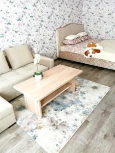 a living room with a couch and a coffee table at Pae 52 Apartment, Free Parking ,Airport 2km in Tallinn