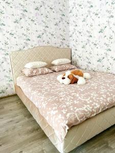 a bed with a stuffed animal sitting on it at Pae 52 Apartment, Free Parking ,Airport 2km in Tallinn
