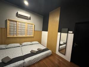 a bedroom with a large bed and a window at Tatami D'Tepi Laut - PANGKOR ISLAND in Pangkor