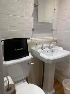 a bathroom with a white toilet and a sink at Albany house in Birmingham