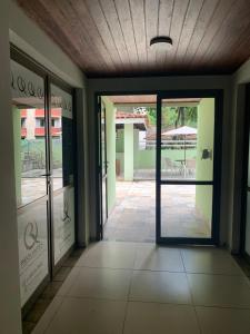 an empty hallway with glass doors in a building at Barra Apart Service in Salvador +34 photos