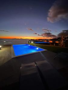 a swimming pool on the roof of a building at night at Madeira Sea Sunshine with heated pool in Ribeira Brava