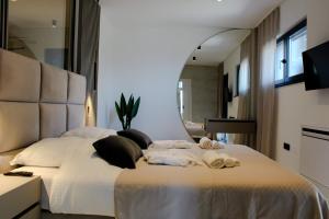 a bedroom with a large bed with towels on it at The Five Stars Croatia in Novi Vinodolski +28 photos