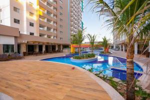 a swimming pool in the middle of a building at Enjoy Resort em frente Thermas até 5 pessoas in Olímpia