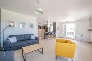 a living room with a couch and chairs and a table at Sunny Lake by Plaza - Proche Disneyland Paris in Serris +8 photos