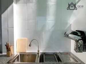 a kitchen with a sink and a counter top at DeMi Homestay - Châu Đốc in áº¤p VÄ©nh ÃÃ´ng