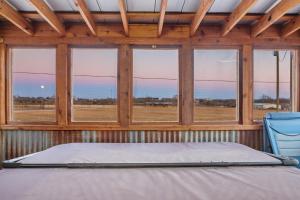 a bedroom with a bed and a window with a view at Moon View in Fredericksburg