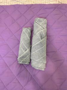 a pair of grey ties sitting on a purple quilt at Vahe’s family guests house in Yerevan