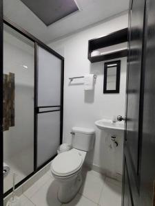 a white bathroom with a toilet and a sink at Casa Horeb in Salento