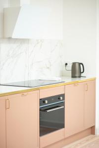 a kitchen with a stove and a counter top at Modern 3BR Duplex Apartment in Nyhavn w Private Balcony in Copenhagen