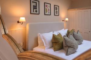 a bedroom with a bed with pillows on it at The Yard in Bath Hotel in Bath