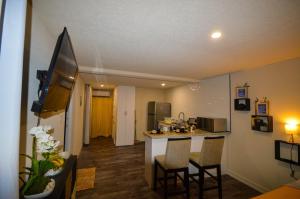 a kitchen with a table and chairs in a room at Dorvic Cottage in Bridgetown
