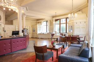 a living room with a couch and a table at Hotel Markgräfler Hof in Karlsruhe