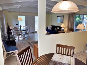 a living room and dining room with a table and chairs at SEA COTTAGE APARTMENT Duplex in Jekyll Island
