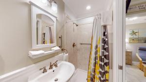 a white bathroom with a sink and a shower at BEACHY SISTERS B Duplex in Jekyll Island