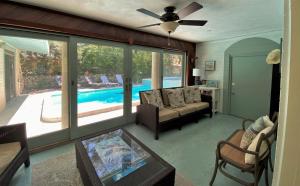 a living room with a couch and a swimming pool at KISSES COTTAGE home in Jekyll Island