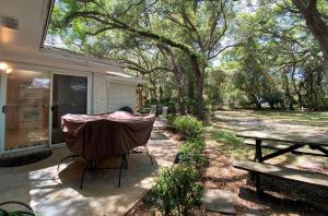 a backyard with a grill and a picnic table at HOLLAND HOUSE DUPLEX Duplex in Jekyll Island