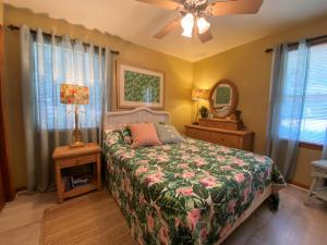 a bedroom with a bed and a ceiling fan at HOLLAND HOUSE DUPLEX Duplex in Jekyll Island
