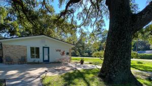 a house with a table and a tree at CUDDLEFISH home in Jekyll Island