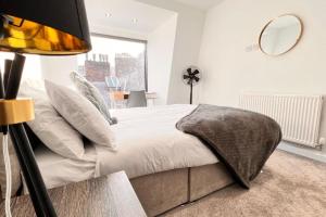 a bedroom with a bed and a large window at Luxury Penthouse in Merseyside, Waterfront in Liverpool