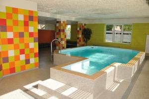a large swimming pool in a room at Strenči Guesthouse in Strenči