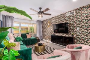 a living room with green furniture and a fireplace at Groovy Old Town Scottsdale Condo in Scottsdale